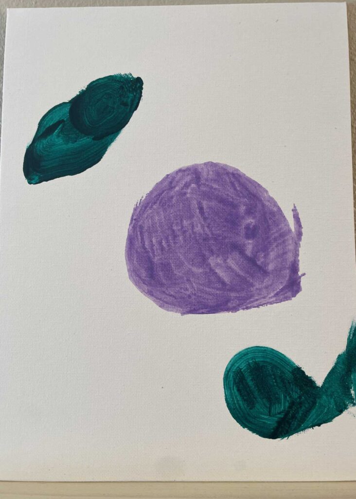 A colorful abstract painting on canvas features a large purple circle with green brush strokes, created during an art activity at the senior living community.