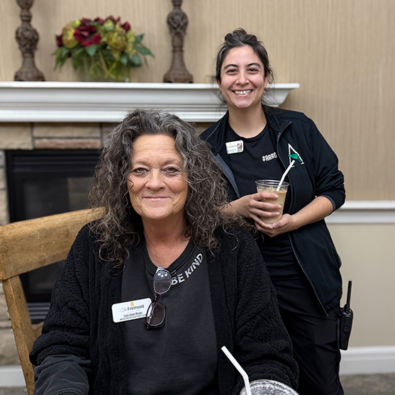 Two women on the Fremont Senior Living team smile, highlighting team spirit.