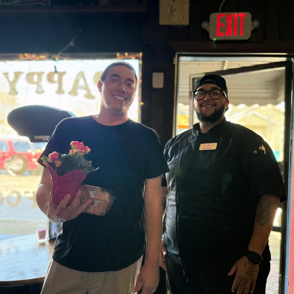 Two men smile in a local business on Small Business Day.